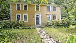 A two-story yellow house with a stone pathway leading to the front door. - Historic Huntington Home - Walk to Westfield River (Huntington)