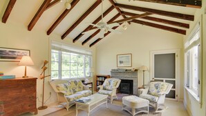 A cozy living room with wooden beams, a fireplace, and comfortable seating. - Mattapoisett Home on 7 Acres w/ Private Beach! (Mattapoisett)