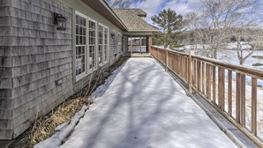 A covered walkway with a wooden railing, leading to a covered porch area. - Waterfront Ipswich Escape: 2 Miles to Crane Beach! (Ipswich)