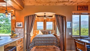 A bedroom with a bed, a ceiling fan, and a view of the mountains. - 28 Mi to Yosemite: Lovely Mtn Cottage w/ Deck! (North Fork)