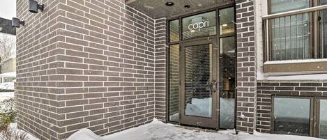 A brick building with a glass entrance labeled "capri".
