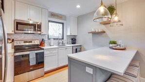 A modern kitchen with white cabinets, stainless steel appliances, and a large island. - Seabrook Island Golf Resort Condo Near Beach! (Seabrook Island)