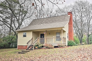 A two-story house with a front porch, a brick chimney, and a small front yard. - Tranquil Retreat w/ Dock on Lake Hamilton! (Hot Springs)