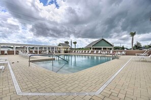 An indoor swimming pool with lounge chairs and a covered seating area. - Resort Access: Pet-friendly Home in The Villages! (The Villages)