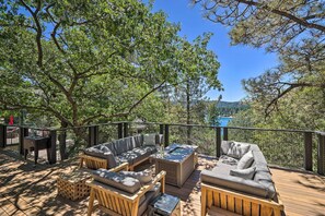 An outdoor deck with a sofa, a coffee table, and a grill. - Airy Alpine Getaway w/ Lake Arrowhead Views! (Lake Arrowhead)