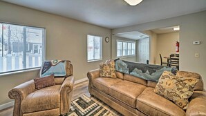 A living room with a brown leather sofa, two armchairs, and a patterned throw blanket. - Red Lodge Retreat w/ Yard - Walk to Restaurants! (Red Lodge)