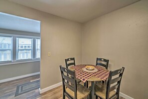 A dining area with a round table, four chairs, and a checkered tablecloth. - Red Lodge Retreat w/ Yard - Walk to Restaurants! (Red Lodge)