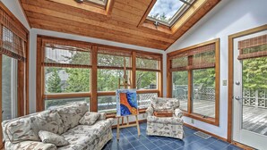 A spacious room with a high ceiling, large windows, and a blue-tiled floor. - Walk to Beach! Hyannis Family Haven w/ Deck (Hyannis)