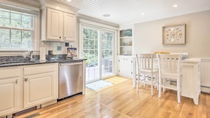 A kitchen with white cabinets, a stainless steel dishwasher, and a wooden floor. - ~ 4 Mi to Dtwn: Chatham Home w/ Fire Pit (South Chatham)
