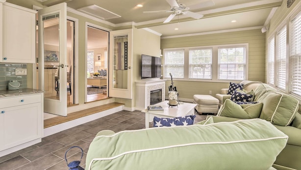 A spacious living area with a green sofa, a fireplace, and a television. - ~ 4 Mi to Dtwn: Chatham Home w/ Fire Pit (South Chatham)