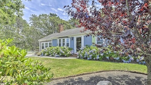 A single-story house with a front porch, surrounded by a well-maintained lawn and flowering plants. - ~ 4 Mi to Dtwn: Chatham Home w/ Fire Pit (South Chatham)