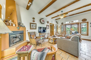 A cozy living room with a fireplace, comfortable seating, and a television.