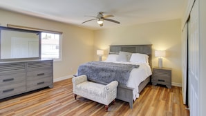 A bedroom with a bed, nightstands, a dresser, a chair, and a ceiling fan. - Townhome w/ Pool Access, Near Dtwn Palm Springs! (Palm Springs)