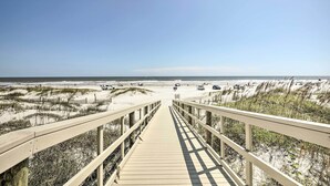 A wooden boardwalk leading to a beach with dunes and a clear sky. - St Augustine Condo w/ Direct Ocean Access! (St. Augustine)
