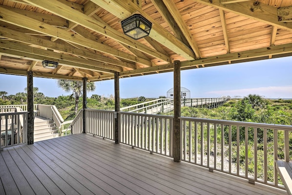 A wooden deck with a railing, a staircase, and a view of the surrounding landscape. - St Augustine Condo w/ Direct Ocean Access! (St. Augustine)