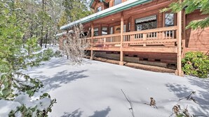 A wooden cabin with a covered porch and a snow-covered driveway. - Near Bear Valley: Peaceful Arnold Home w/ Hot Tub (Arnold)