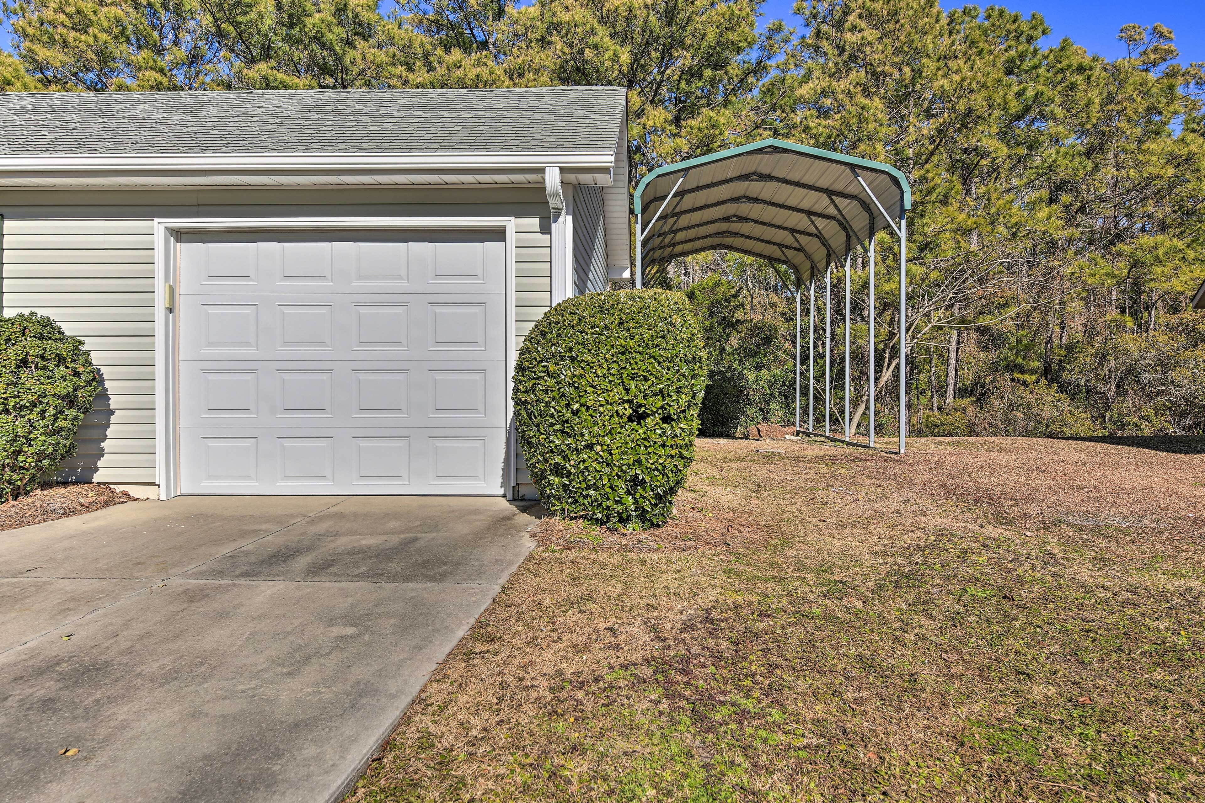 A single-story house with a garage, a covered porch, and a well-maintained lawn.