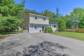 A two-story house with a stone foundation and a front porch. - Cute Ellsworth Home w/ Deck, 16 Mi to Acadia! (Ellsworth)