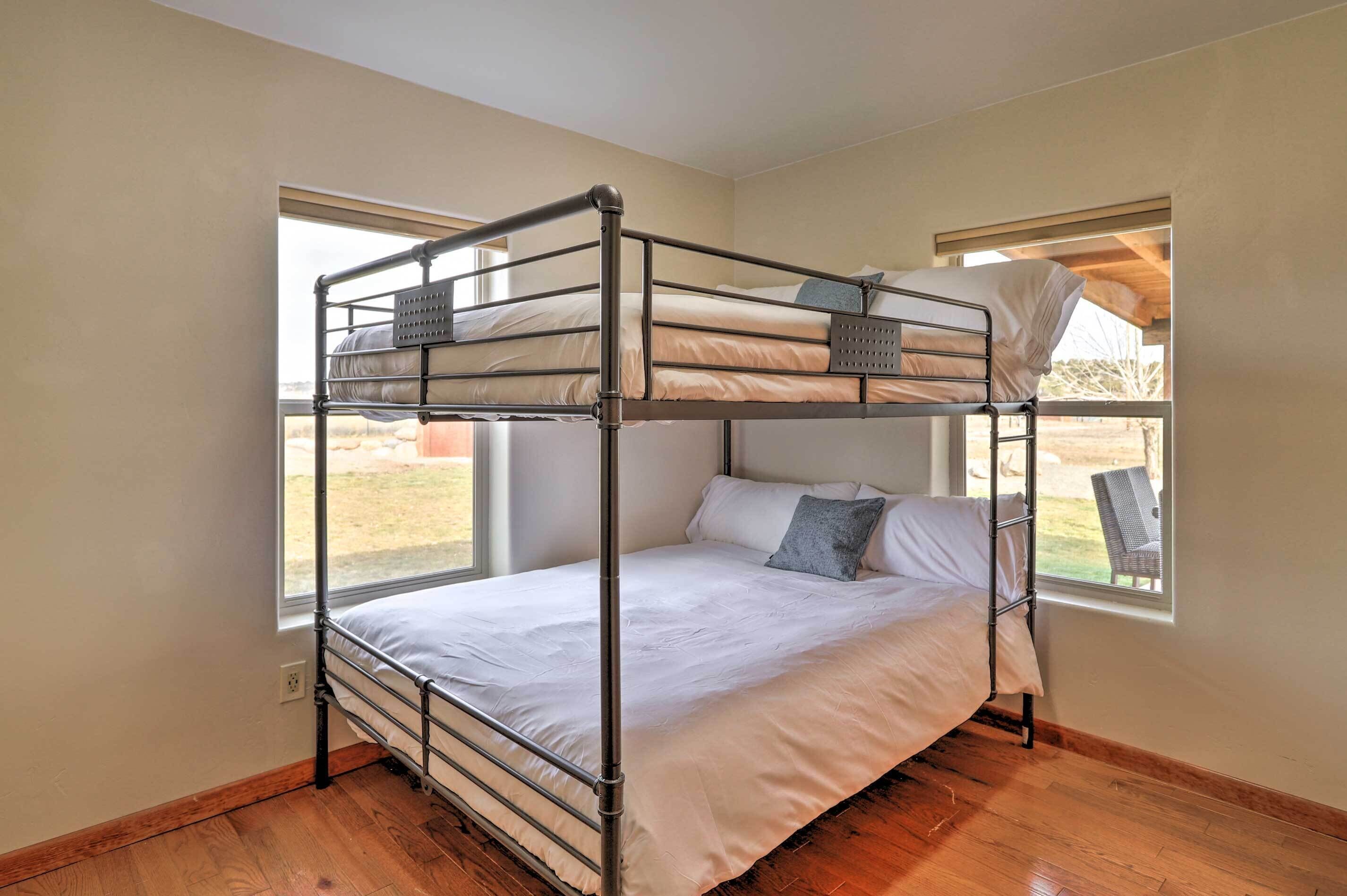 A bunk bed room with a window providing a view of the outdoors.