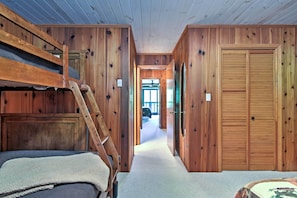 A wooden interior with bunk beds, a hallway, and a door. - Year-round Fun in Beech Mountain! Condo w/ Balcony (Banner Elk)