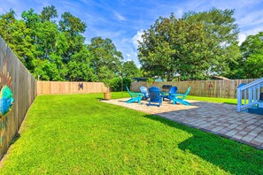 Enjoy a serene outdoor space surrounded by lush green trees and a beautifully maintained lawn.