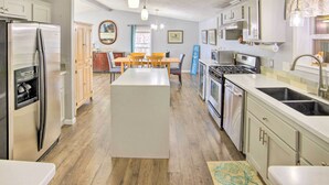 A modern kitchen with a central island, stainless steel appliances, and wooden cabinets. - Waterfront Michigan Center Home w/ Boat Dock! (Michigan Center)