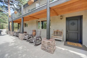 A two-story building with a balcony, stone pillars, and a wooden deck. - Homey Mtn View Escape: 11 Mi to Garden of the Gods (Cascade)