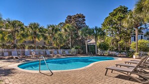 A swimming pool with lounge chairs and a fenced area, surrounded by palm trees and a clear blue sky. - Renovated Gem w/ Pool Access: 1/4 Mi to Beach (Santa Rosa Beach)