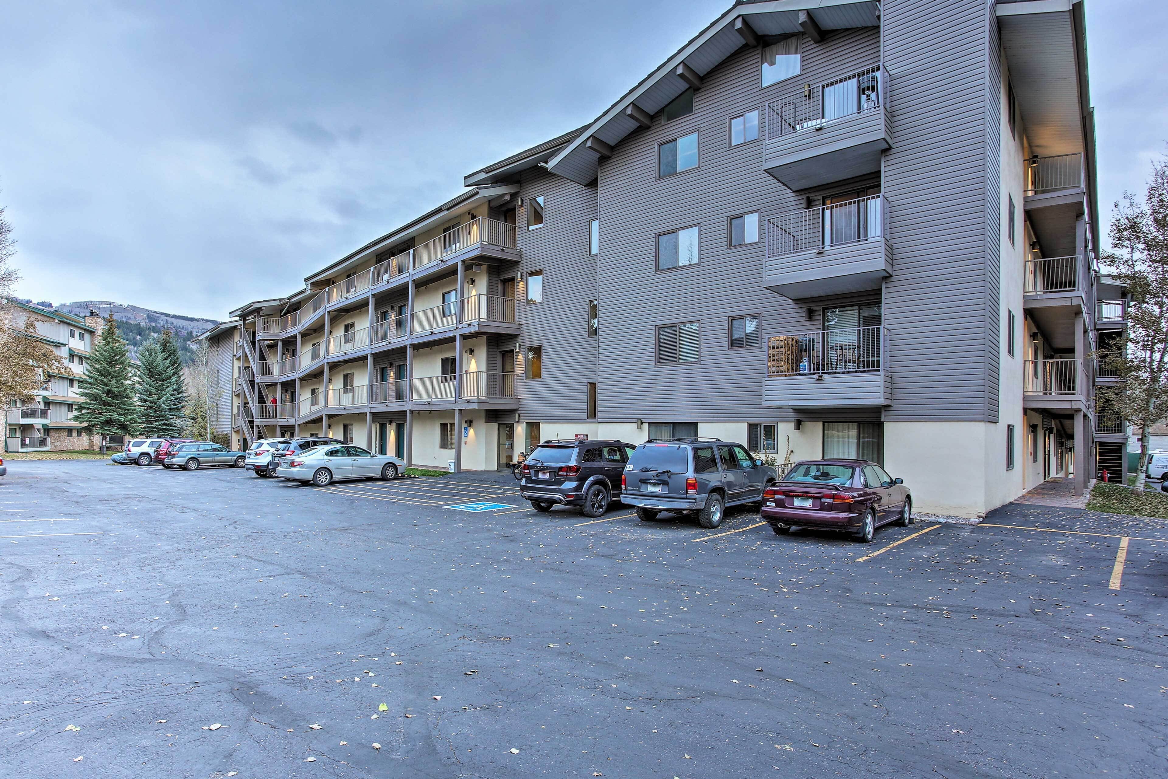 A multi-story parking garage with several cars parked.