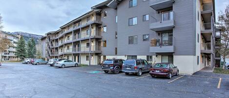 A multi-story parking garage with several cars parked.