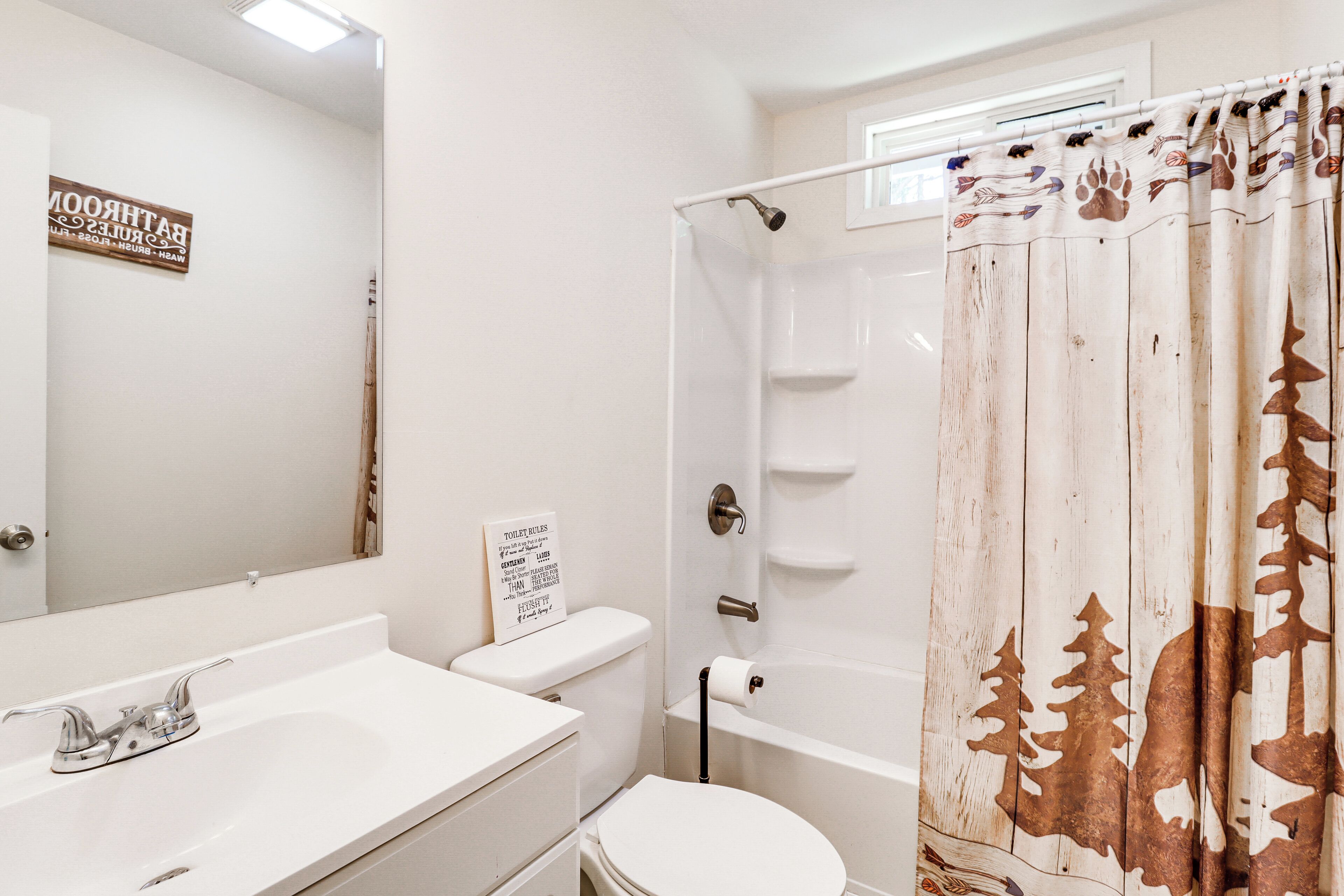 A bathroom with a white sink, toilet, and bathtub.