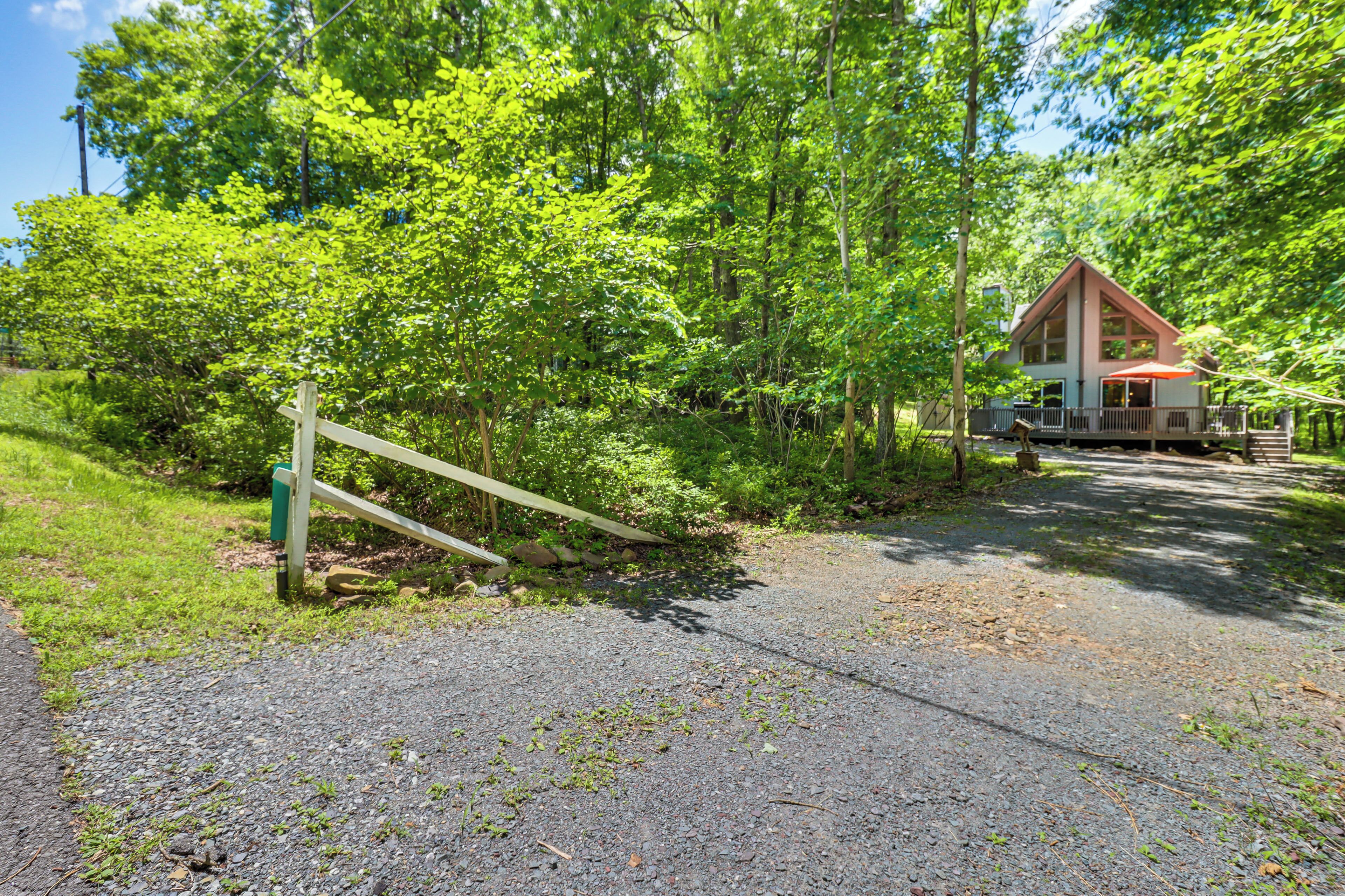A house with a porch and a gravel driveway.