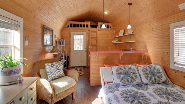 A cozy wooden cabin with a loft bed, a dining area, and a small kitchen. - Cozy Calabash Studio ~ 4 Mi to Sunset Beach! (Sunset Beach)