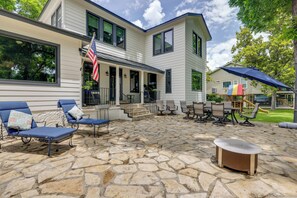 A patio with stone flooring, outdoor furniture, and a flag. - Spacious Lake Placid Retreat w/ Gorgeous Views! (Seguin)
