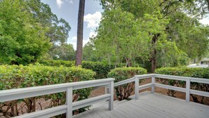 A wooden deck with white railings, surrounded by lush greenery and trees. - Getaway < 9 Mi to Historic Downtown Ocala (Ocala)