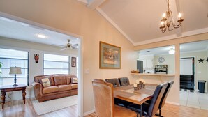 A dining area with a wooden table, leather chairs, and a chandelier. - Getaway < 9 Mi to Historic Downtown Ocala (Ocala)