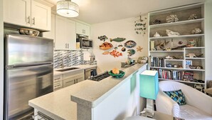 A modern kitchen with white cabinets, stainless steel appliances, and a central island. - Lush Molokai Island Oasis w/ Private Pool + Beach! (Kaunakakai)