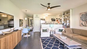 A modern living room with a sofa, coffee table, and a dining area with chairs and a table. - Lush Molokai Island Oasis w/ Private Pool + Beach! (Kaunakakai)