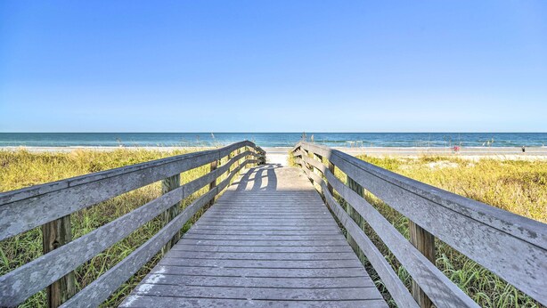 A wooden boardwalk leading to a beach with clear skies. - Indian Rocks Beach Home - 2 Blocks to Beach! (Indian Rocks Beach)