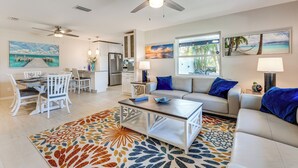 A spacious living area with a dining table, sofa, and ceiling fan. - Indian Rocks Beach Home - 2 Blocks to Beach! (Indian Rocks Beach)