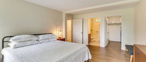 A bedroom with a bed, bedside table, and a wardrobe.