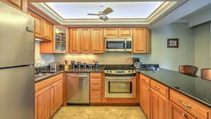 A kitchen with wooden cabinets, stainless steel appliances, and a skylight. - Marco Island Condo w/ Patio: Steps to Beach Access (Marco Island)