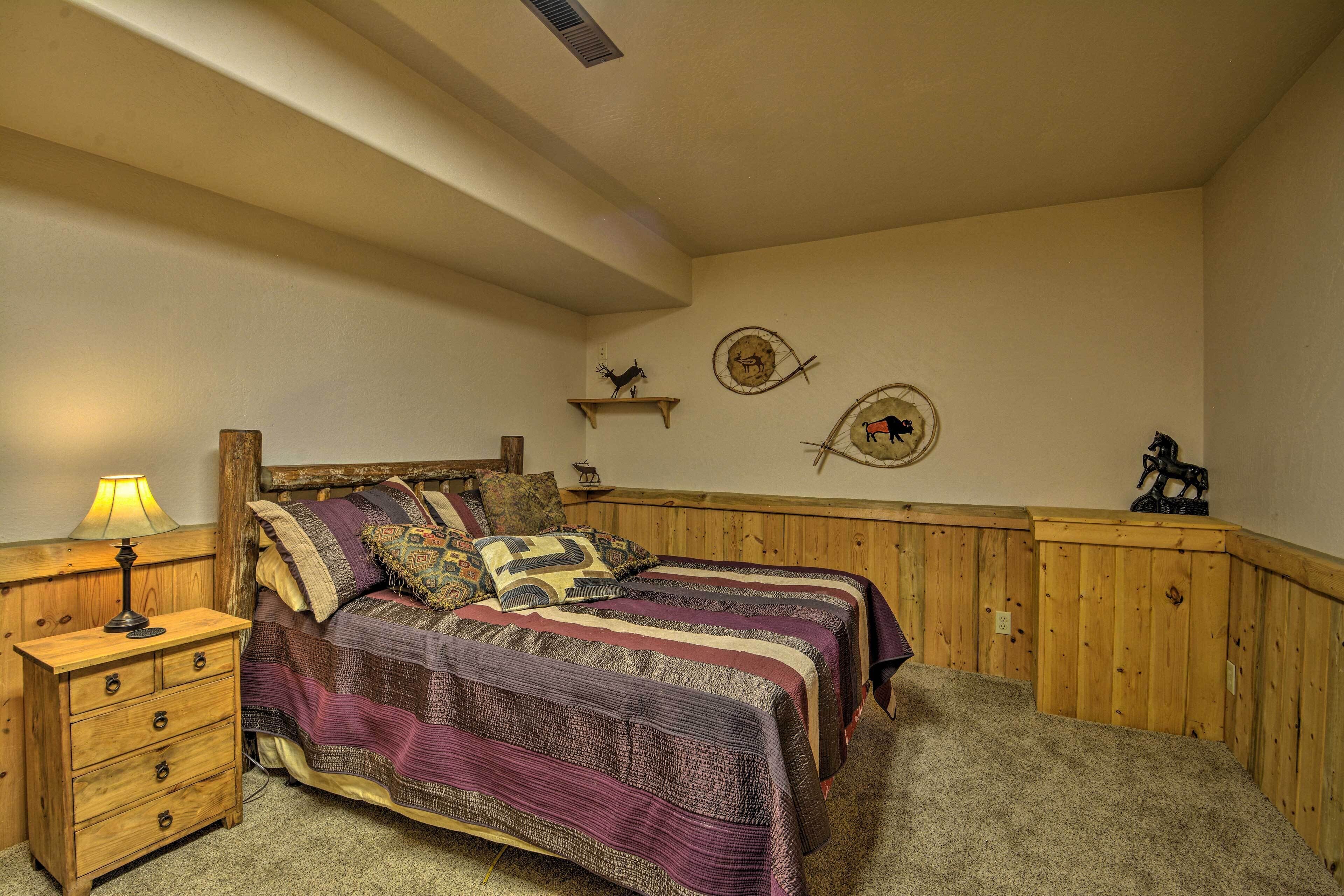 Un dormitorio con dos camas, cabeceros de madera, una mesita de noche y una lámpara.