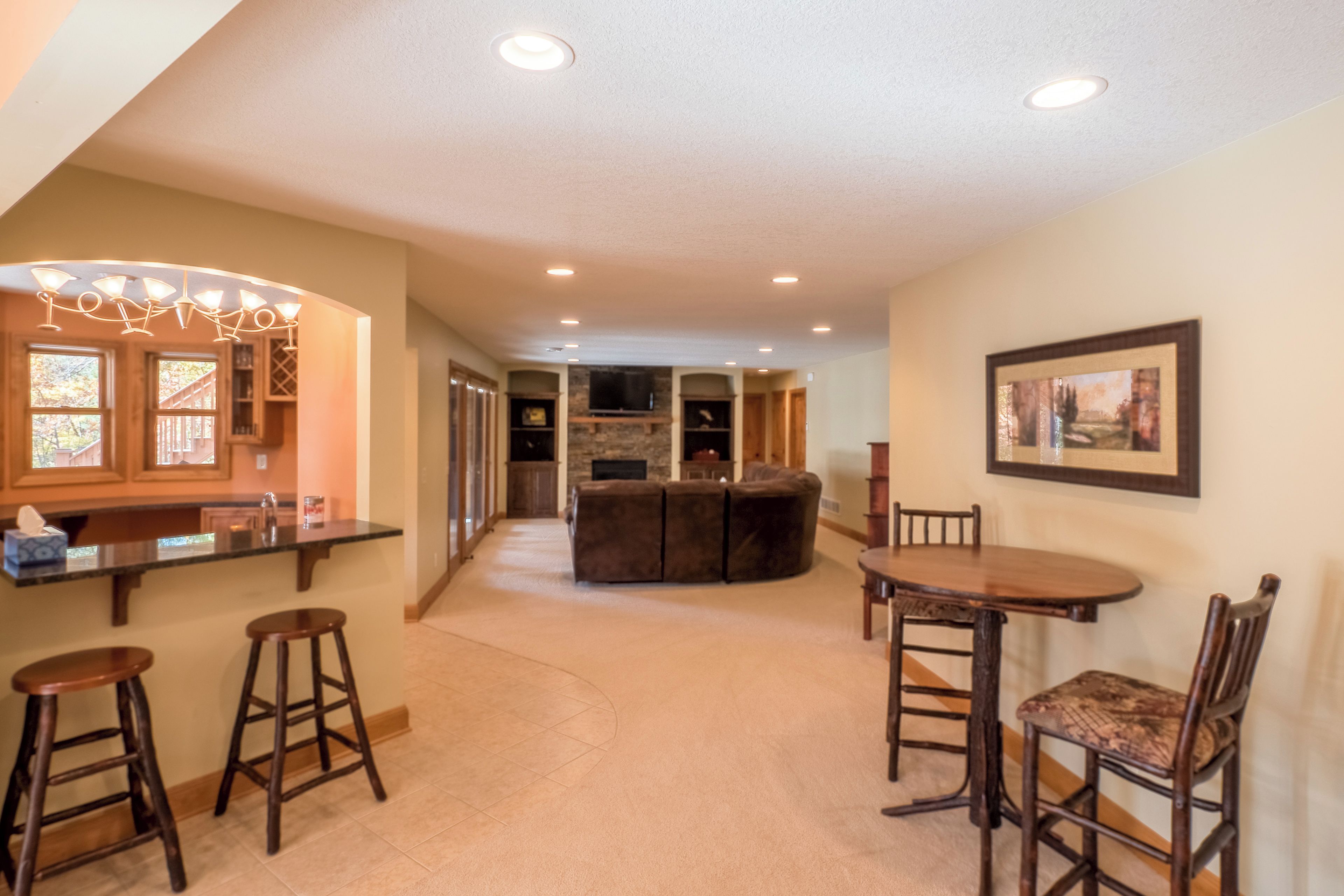 A spacious living area with a kitchen, dining table, and bar area.