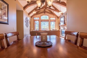 A dining area with a wooden table, chairs, and a decorative vase. - Lakefront Retreat at Giants Ridge: Golf, Hike, Ski (Aurora)
