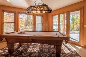 A pool table in a room with large windows and a patterned rug. - Lakefront Retreat at Giants Ridge: Golf, Hike, Ski (Aurora)