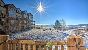 A snow-covered courtyard with a wooden fence, buildings with balconies, and a clear blue sky. - 2-condo Property w/ Mtn Views by Golf & Ski Resort (Eden)