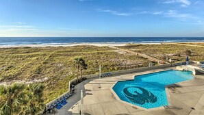 A swimming pool with a shark design, surrounded by beach views and palm trees. - Coastal Orange Beach Condo: Resort + Beach Access! (Orange Beach)