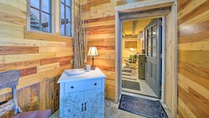 A wooden interior with a desk, lamp, and cabinets. - Country Escape w/ Fire Pit Near French Creek! (Cambridge Springs)