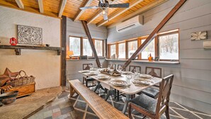 A dining area with a wooden table set for six, benches, and a ceiling fan. - Country Escape w/ Fire Pit Near French Creek! (Cambridge Springs)